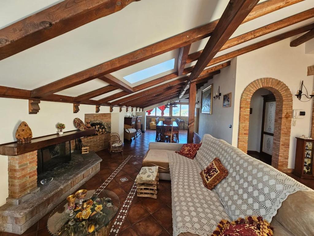a living room with a couch and a fireplace at BlueHorizon in Santa Teresa di Riva