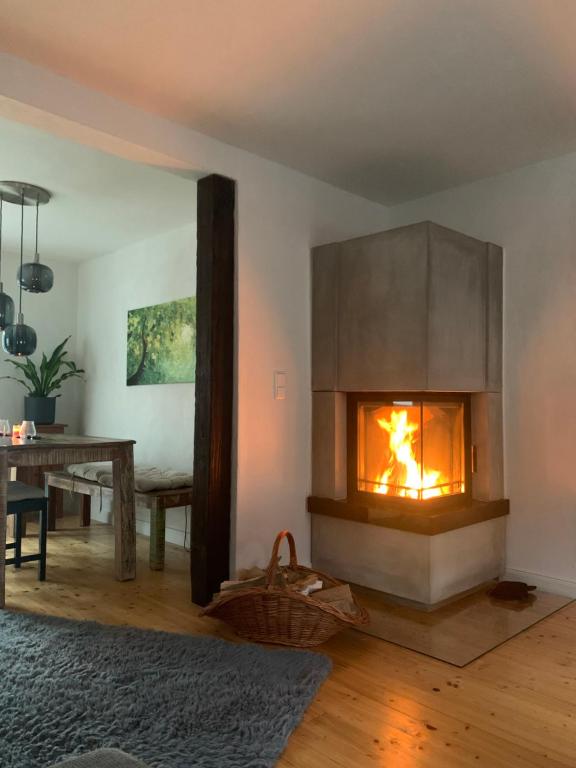 a living room with a fireplace and a table at Auszeit Deluxe in Kirchheim unter Teck