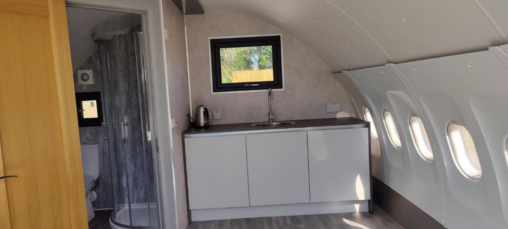a bathroom with a sink and a television on the wall at Canal Stay in Cloondara