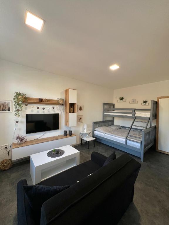 a living room with two bunk beds and a couch at Apartmán v centru Trutnova in Trutnov