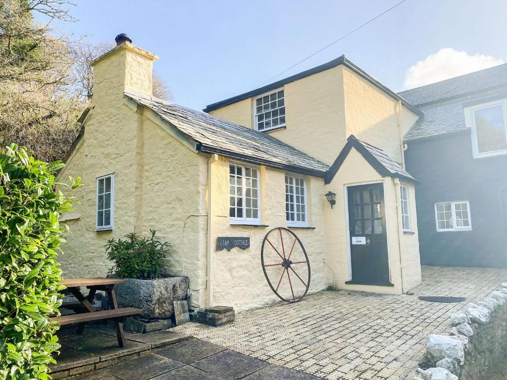 a building with a door and a picnic table at Liam Cottage - Cv13 in Saint Cleer