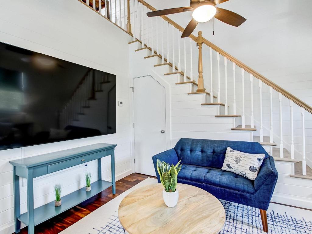 a living room with a blue couch and a table at Beachside Villa Unit 4 in Tybee Island