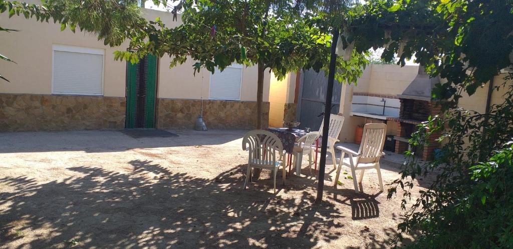 a table and chairs sitting under a tree at L'Hortet de Can Serra in Santander