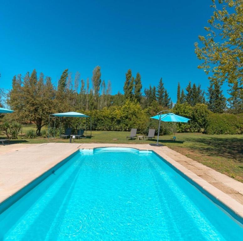 ルシヨンにあるDomaine Plan des Devensの庭の青いスイミングプール(パラソル付)