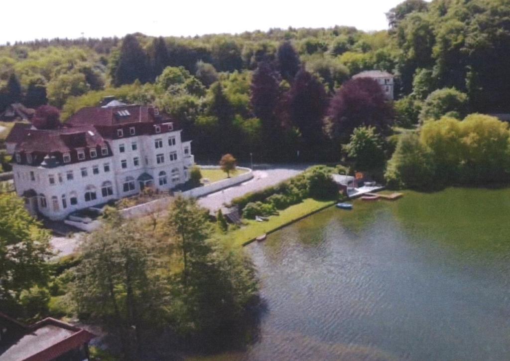 an aerial view of a house and a river at Seeschloss Hotel Kellersee in Eutin