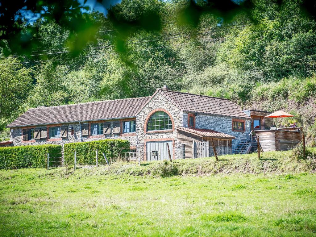 a stone house in the middle of a field at Clos Du Ry De Snaye in Beauraing