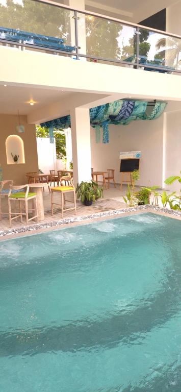 a swimming pool in front of a house at Brizo Paradiso in Matara