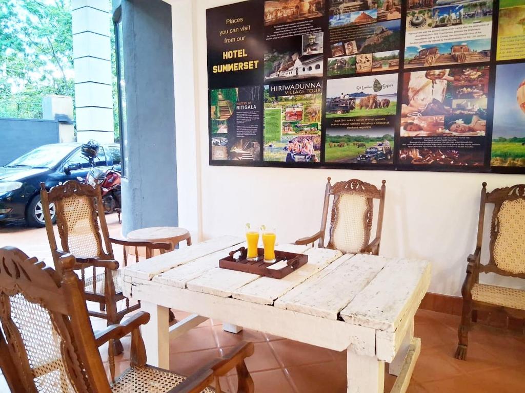 a wooden table with two candles on top of it at SummerSet in Dambulla