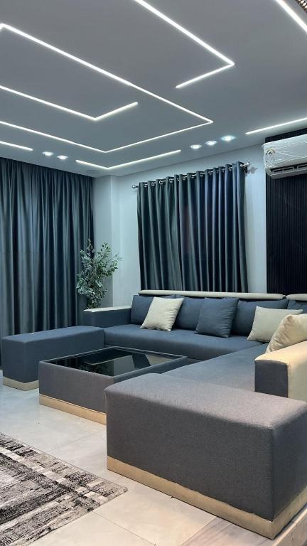 a living room with a couch and a coffee table at Three-bedroom apartment in Mohandessin in Cairo