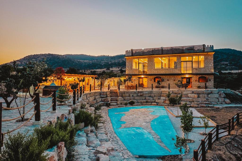 a house with a swimming pool in front of it at Kleos Noble Retreat - Private Estate in Limassol