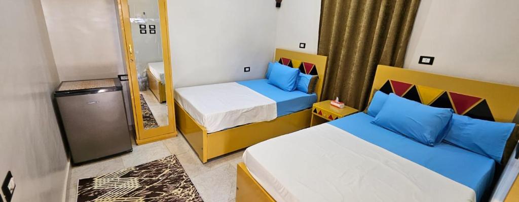 Giường trong phòng chung tại أسوان قريه جزيرة أسوان النجع القبلى