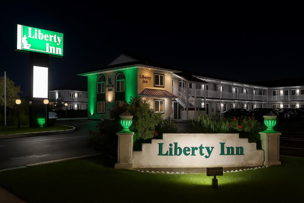 a hotel with a lit up library inn at night at Liberty Inn Absecon Atlantic City in Galloway