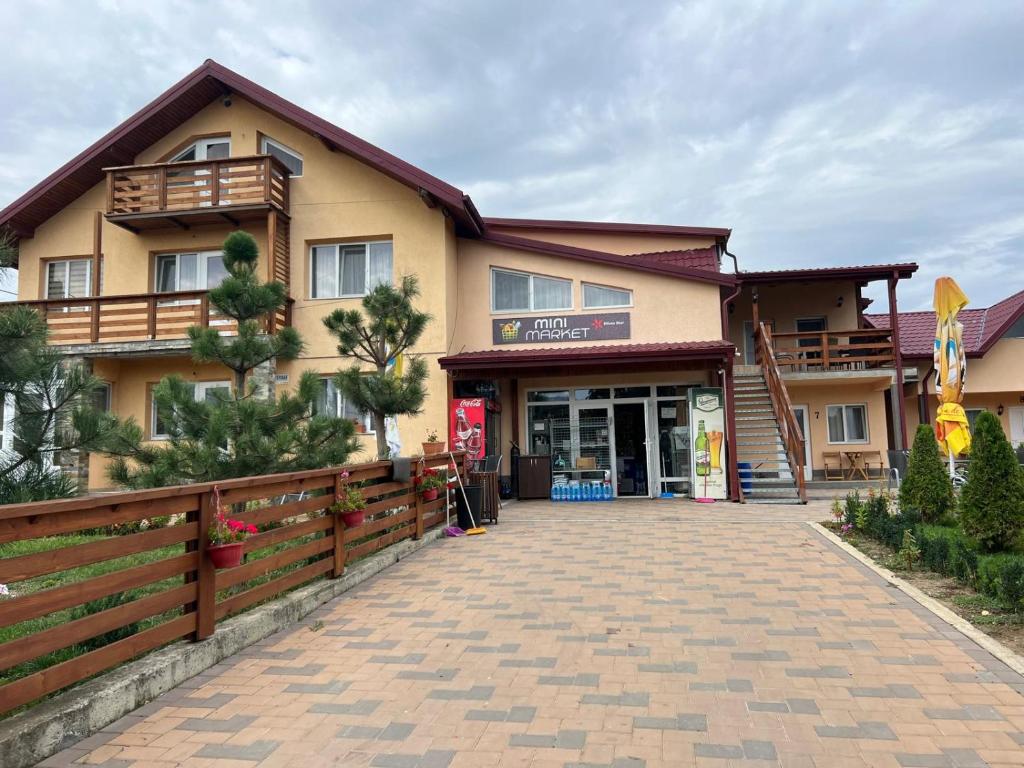a building with a brick driveway in front of it at Vila Onyx in Ţibăneşti