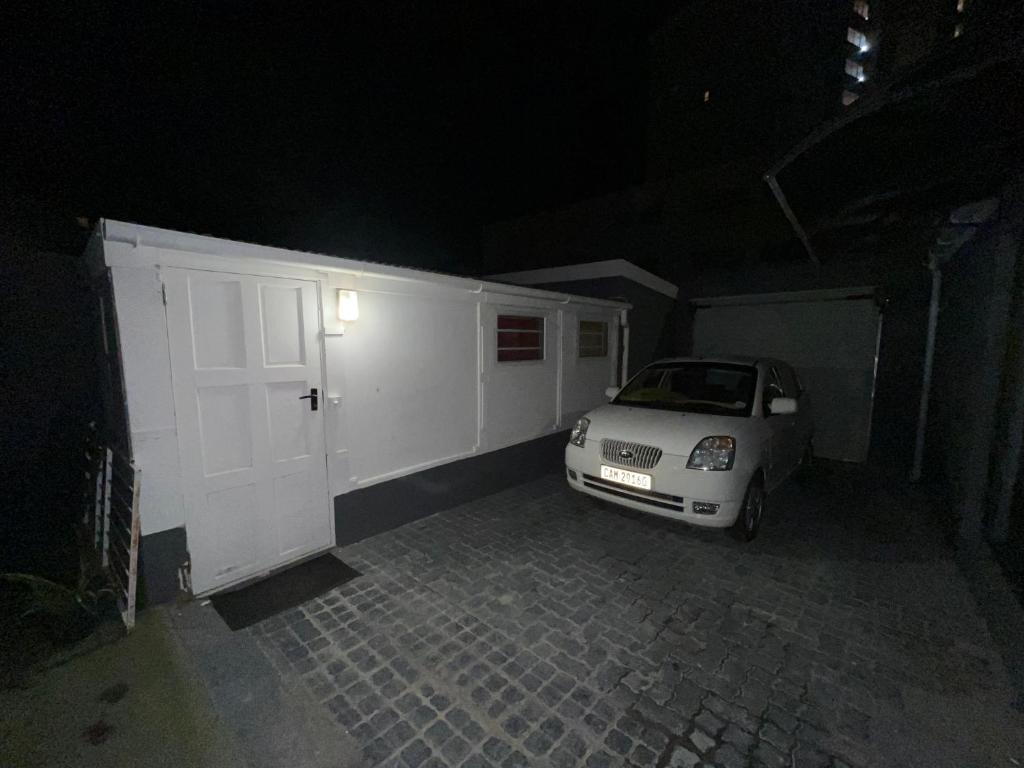 a white car parked in a garage at night at The Pearl at Strand in Strand