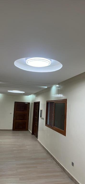 an empty room with a ceiling with a light at Keur Mame Coumba in Saint-Louis