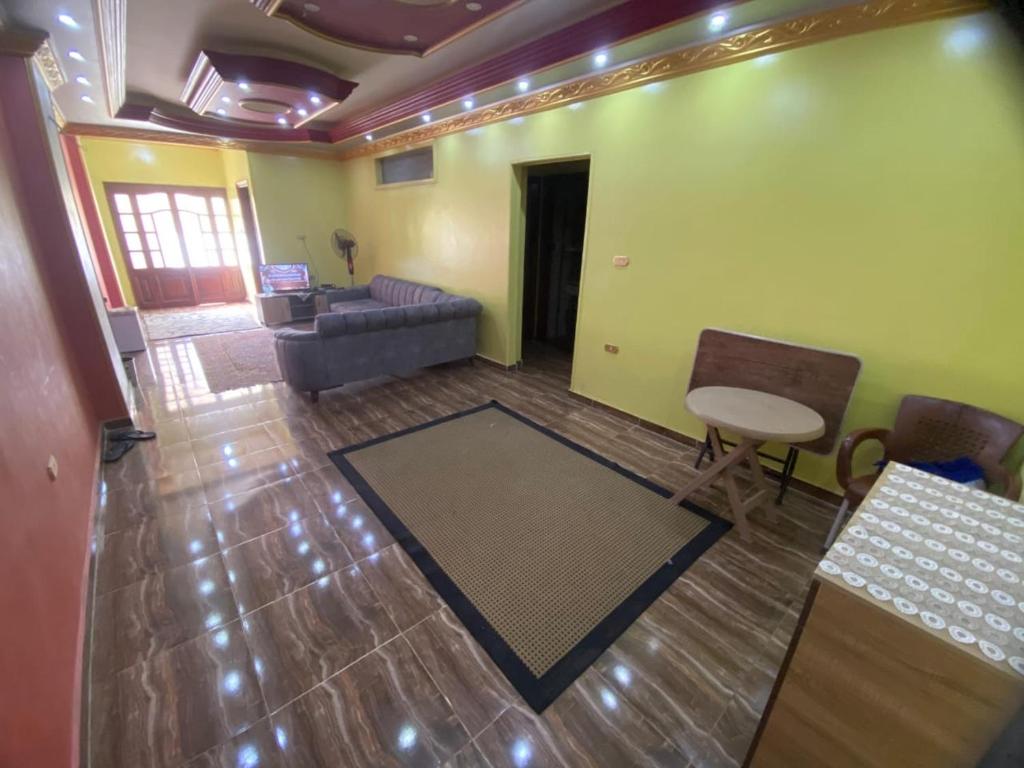 a living room with a couch and a table at شقة من اميز الأماكن بالزقازيق in Kafr az Zand