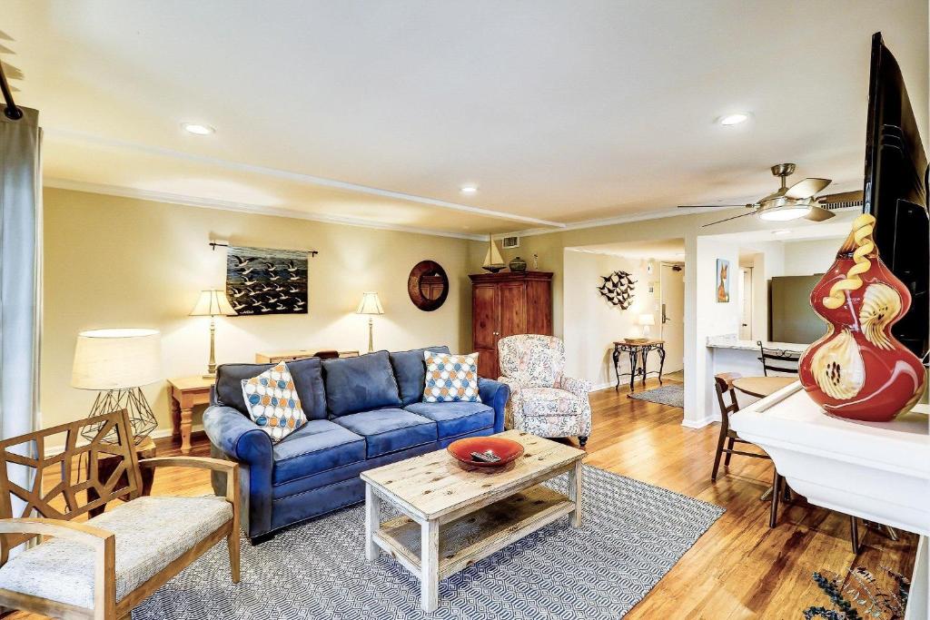 a living room with a blue couch and a table at SG6A: 6A Seagrove Villa in Isle of Palms