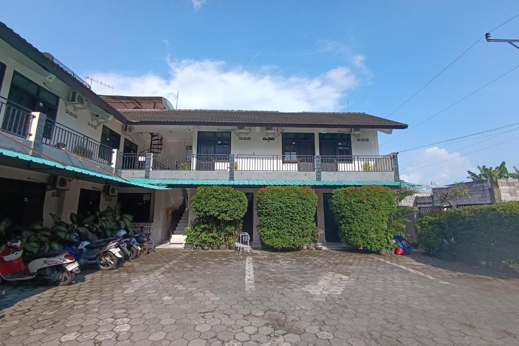 a house with motorcycles parked in front of it at JJ House Kost Exclusive Nologaten in Yogyakarta