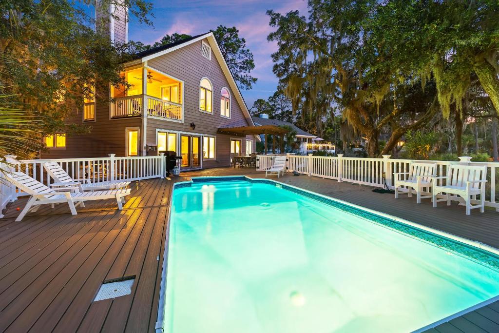 a swimming pool on a deck with a house at MG3080: 3080 Marshgate in Seabrook Island