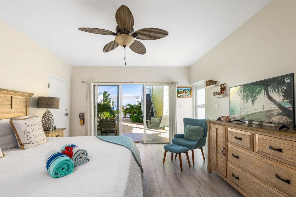 a bedroom with a bed and a ceiling fan at The One Love at Cottages in Sand Bluff