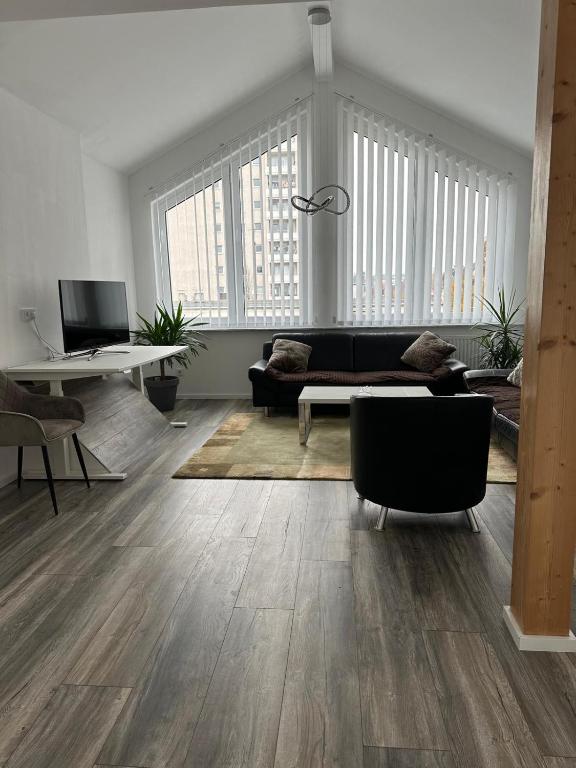 a living room with a couch and a table at Ferienwohnung Steinberg in Dietzenbach