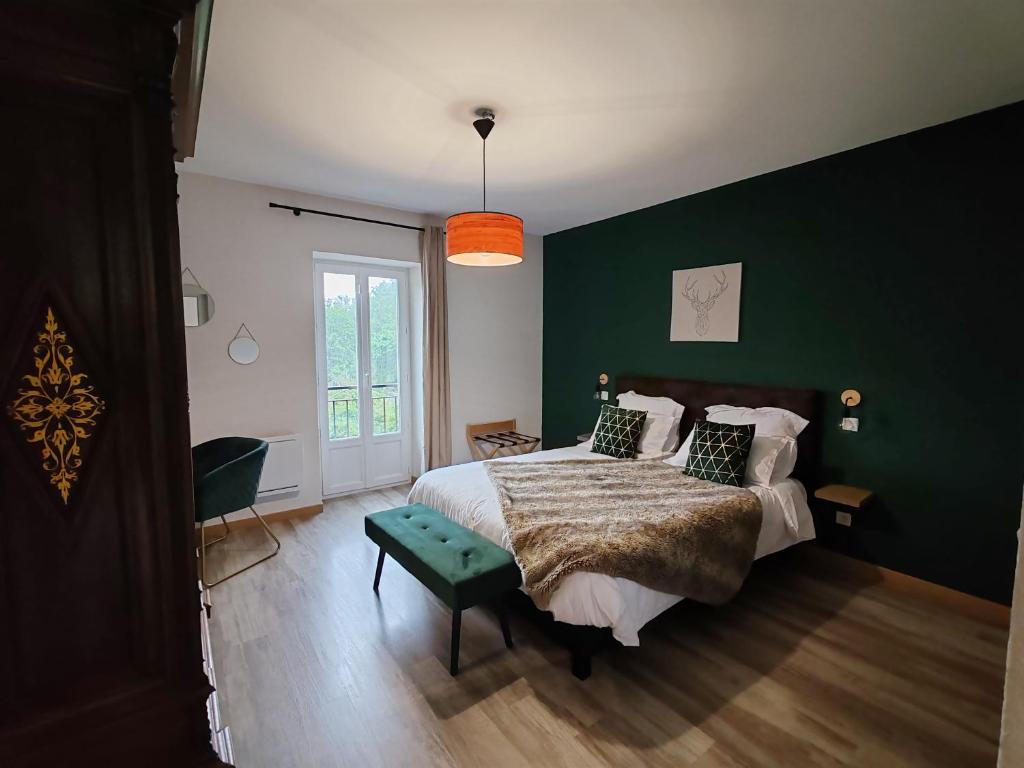 a bedroom with a large bed with a green wall at Chambre d'hôtes casa di l'apa in Venaco
