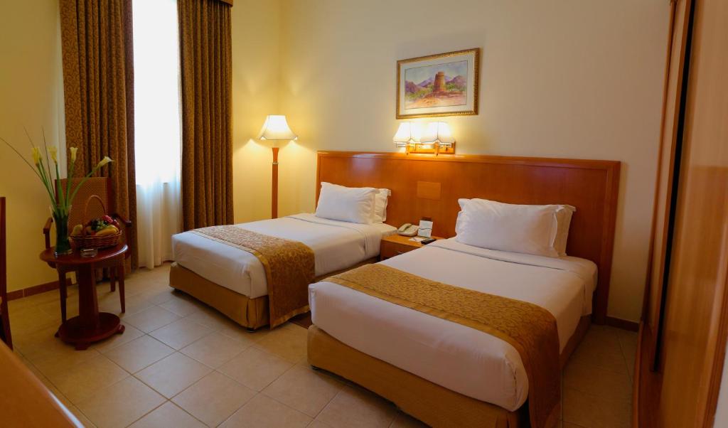 Postel nebo postele na pokoji v ubytování Sharjah Premiere Hotel & Resort