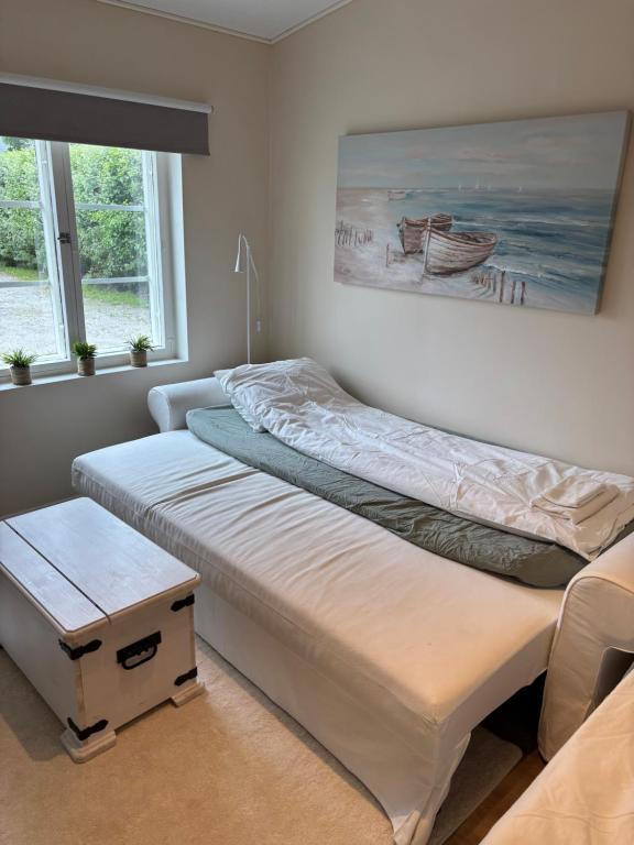 two beds in a room with two windows at Villa Linnea in Hanko