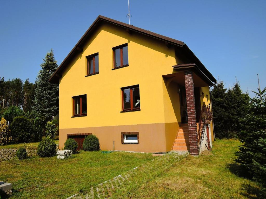 a yellow house on top of a green field at Holiday Home Kolczewo near Baltic Sea Beach in Kołczewo
