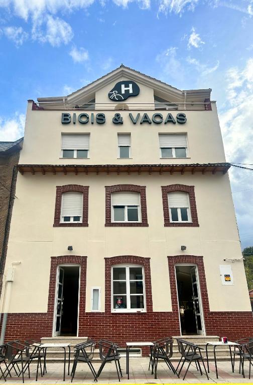 a building with benches in front of it at Bicis & Vacas in La Pola de Gordón