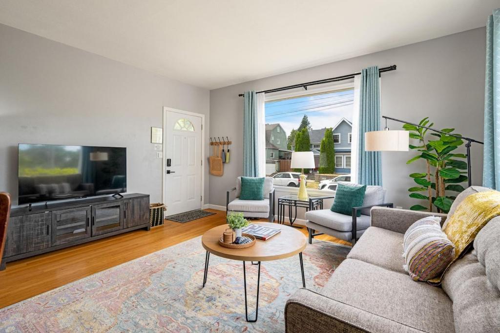 a living room with a couch and a tv at Downtown Home Walk to Restaurants and Waterfront in Tacoma