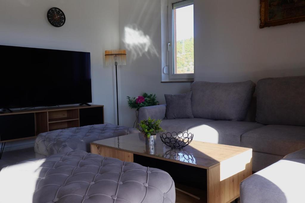 a living room with a couch and a table at Apartmani Ana in Čapljina
