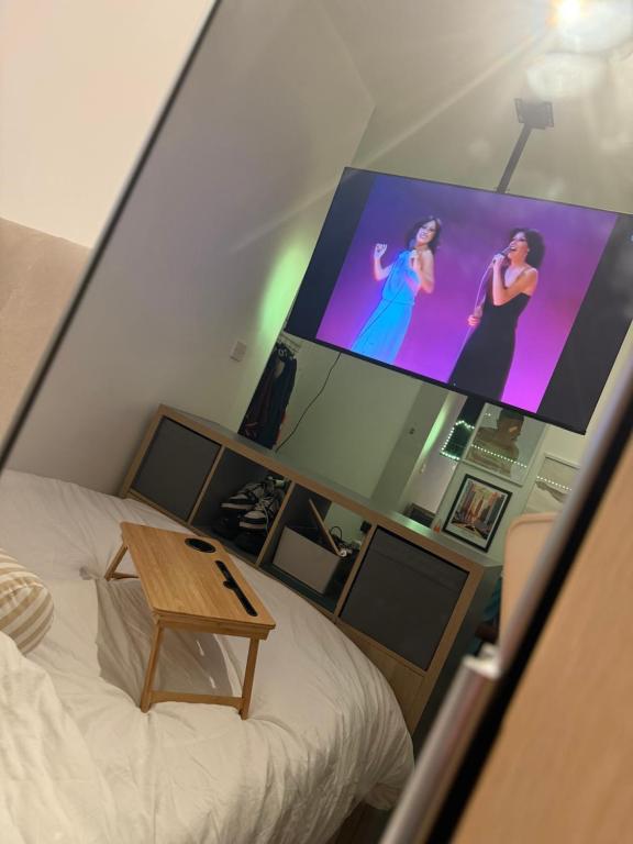 a room with a bed and a large screen at Home From Home in Liverpool