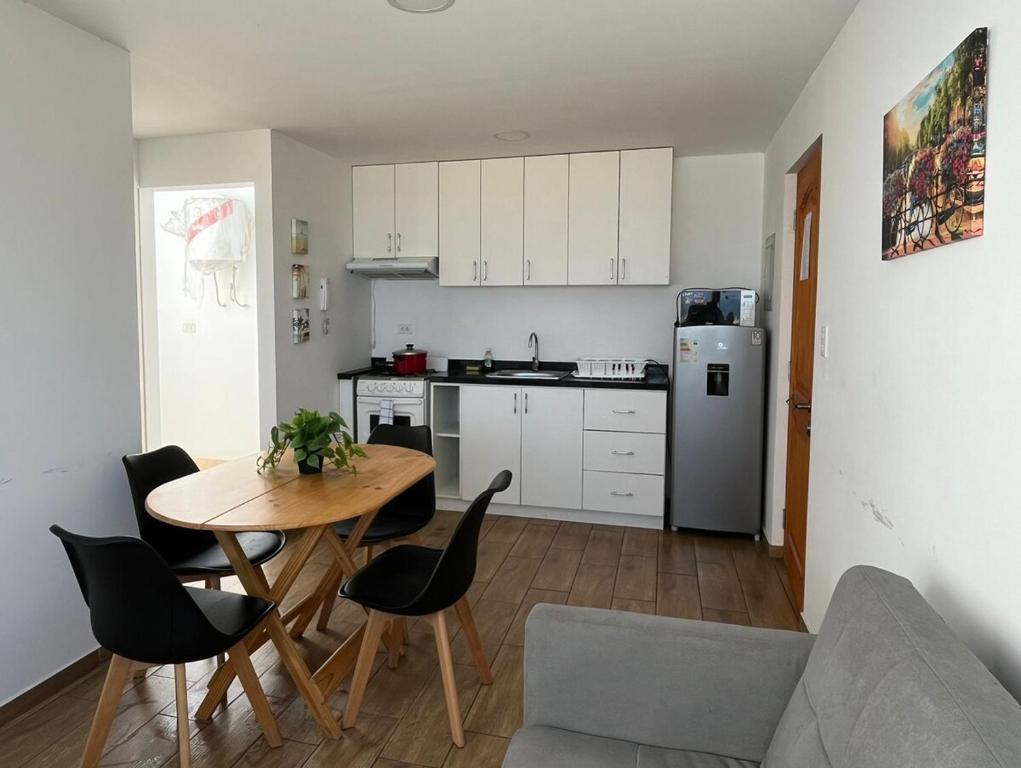 a kitchen and dining room with a table and chairs at Apartment with Beach Exit 204 in Punta Negra