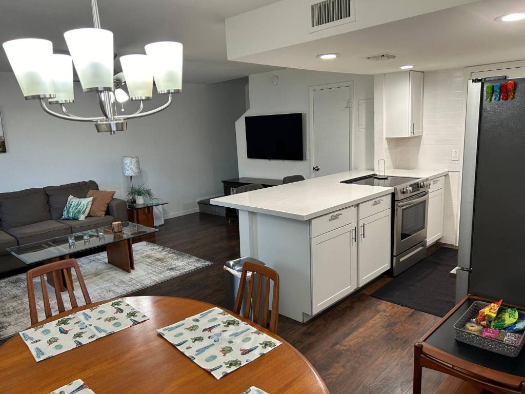 a kitchen and living room with a table and a couch at Desert Dwelling Resort Near Papago Park in Phoenix