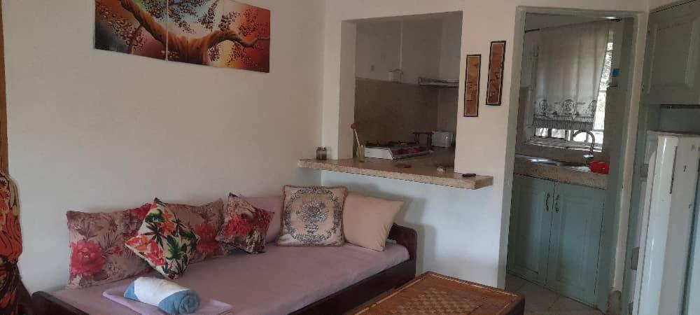 a living room with a pink couch in a room at Victoria Stay in Jinja