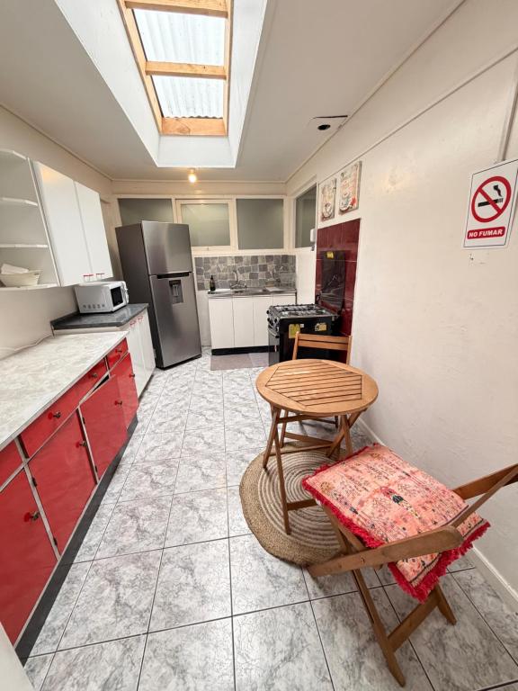 a kitchen with a table and chairs and a stove at Casa Cypresses in Temuco