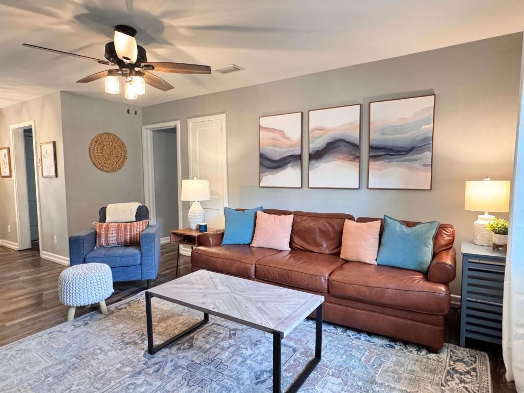 a living room with a brown couch and blue chairs at Restful Retreat with 4 Beds Sleeps 6 in Valdosta