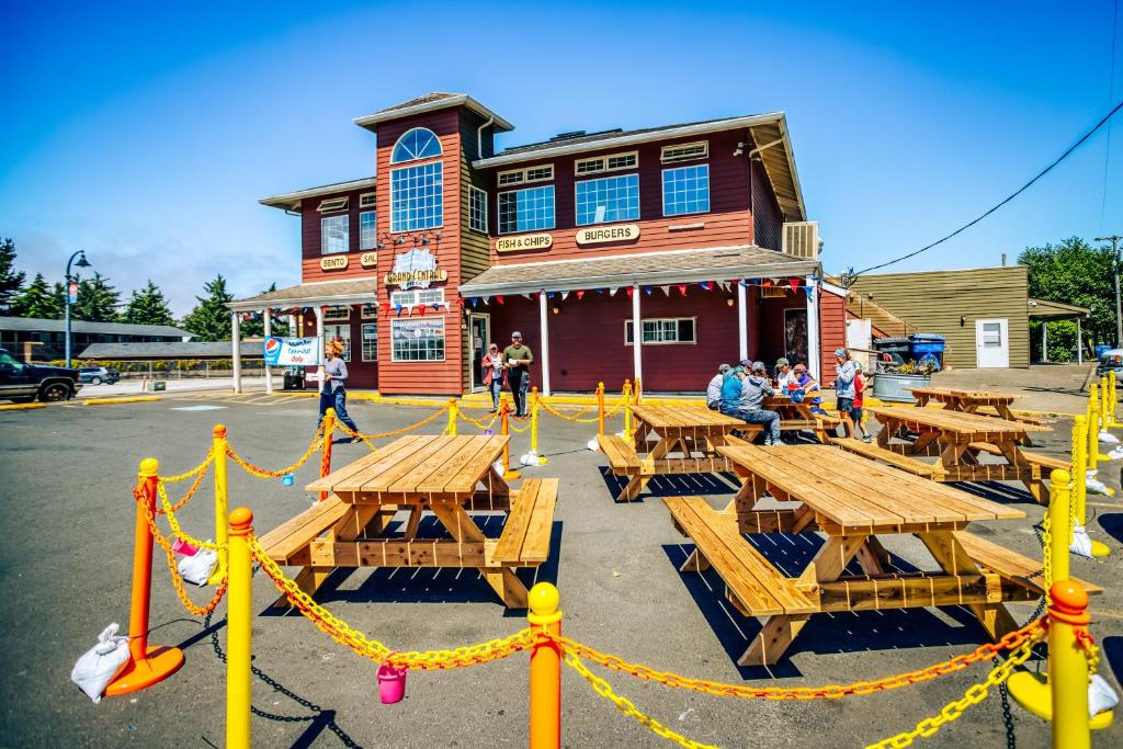 a group of picnic tables in front of a building at Whales Cove in Waldport
