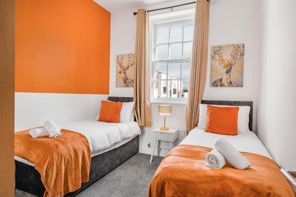WrittleにあるGrace Bartlett House for 5 with Free Parking for 2のオレンジと白の部屋のベッド2台