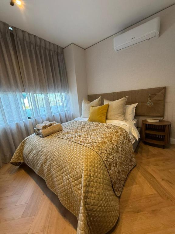 a bedroom with a large bed and a window at Views on August - Penthouse Unit 9 in Cape Town