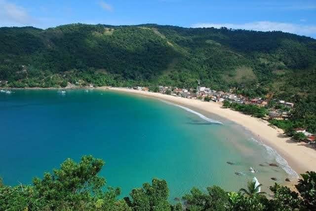 an aerial view of a beach with blue water at casa da Cilene in Angra dos Reis