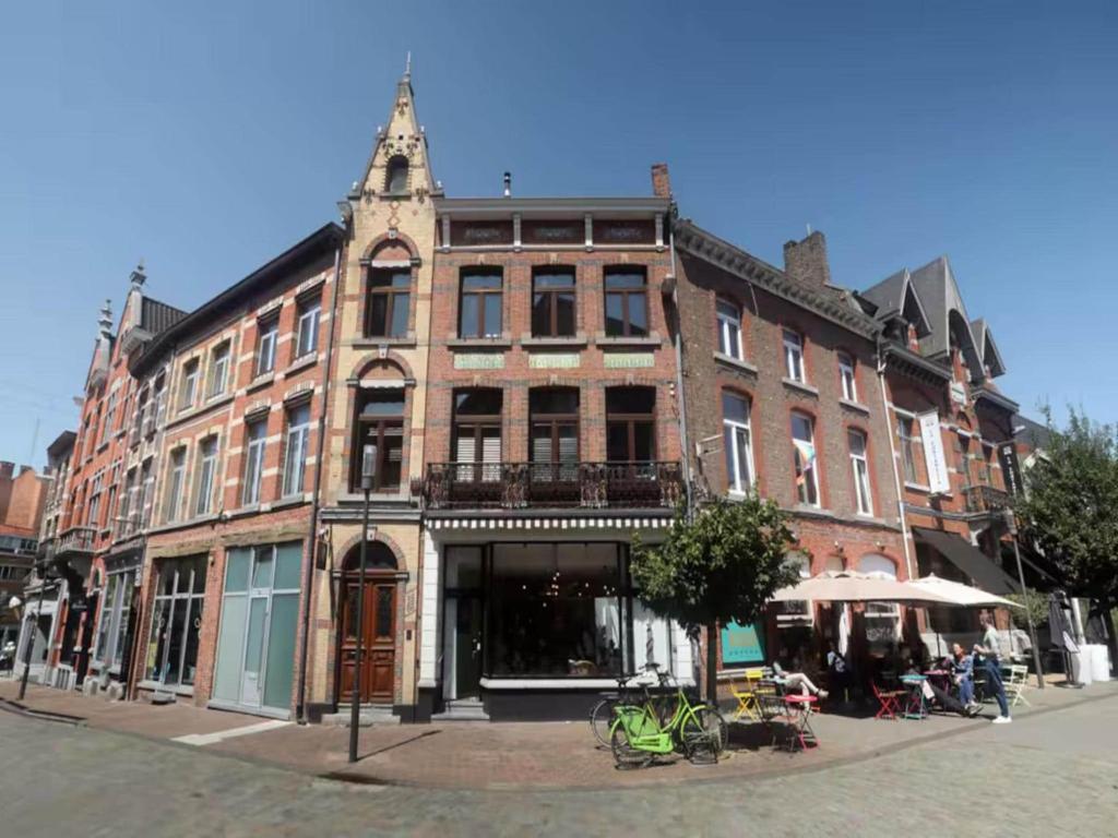 a large brick building on the corner of a street at Holiday home in the heart of Hasselt in Hasselt