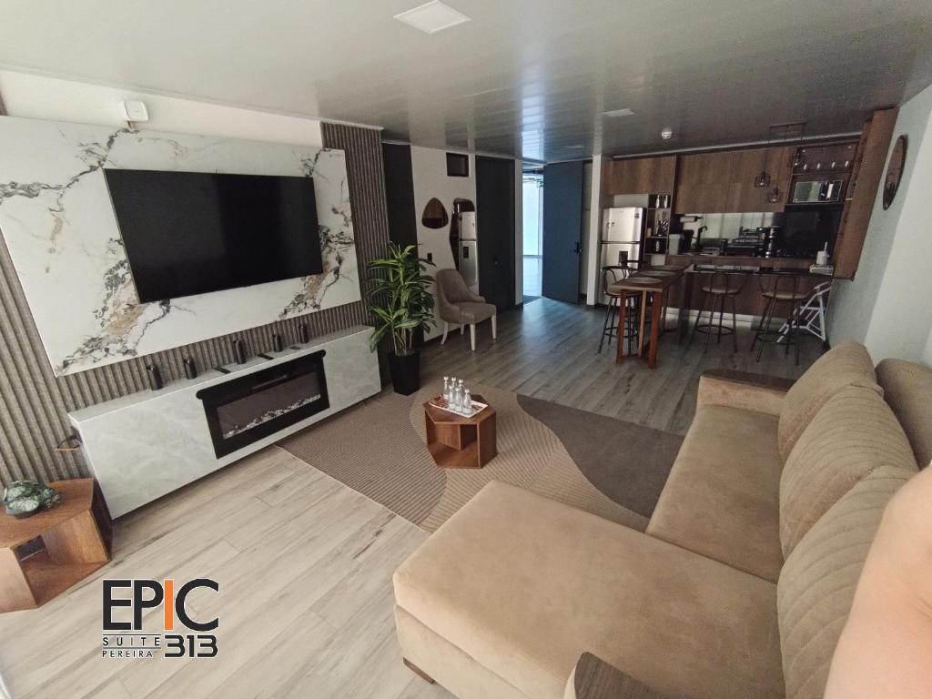 a living room with a couch and a flat screen tv at Epic Suite 313 Deluxe Airport Family 3H 10P in Cuba