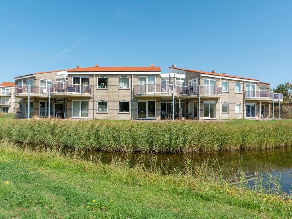 a building on the side of a river at Apartment in Zoutelande near beach in De Zandloper