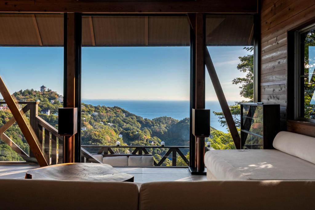 a living room with a view of the ocean at tomaru wool -moku- in Atami