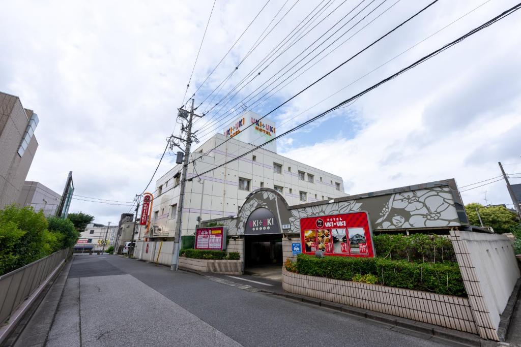 a street with a building with a sign on it at Hotel UKIUKI -Adult Only- in Chiba