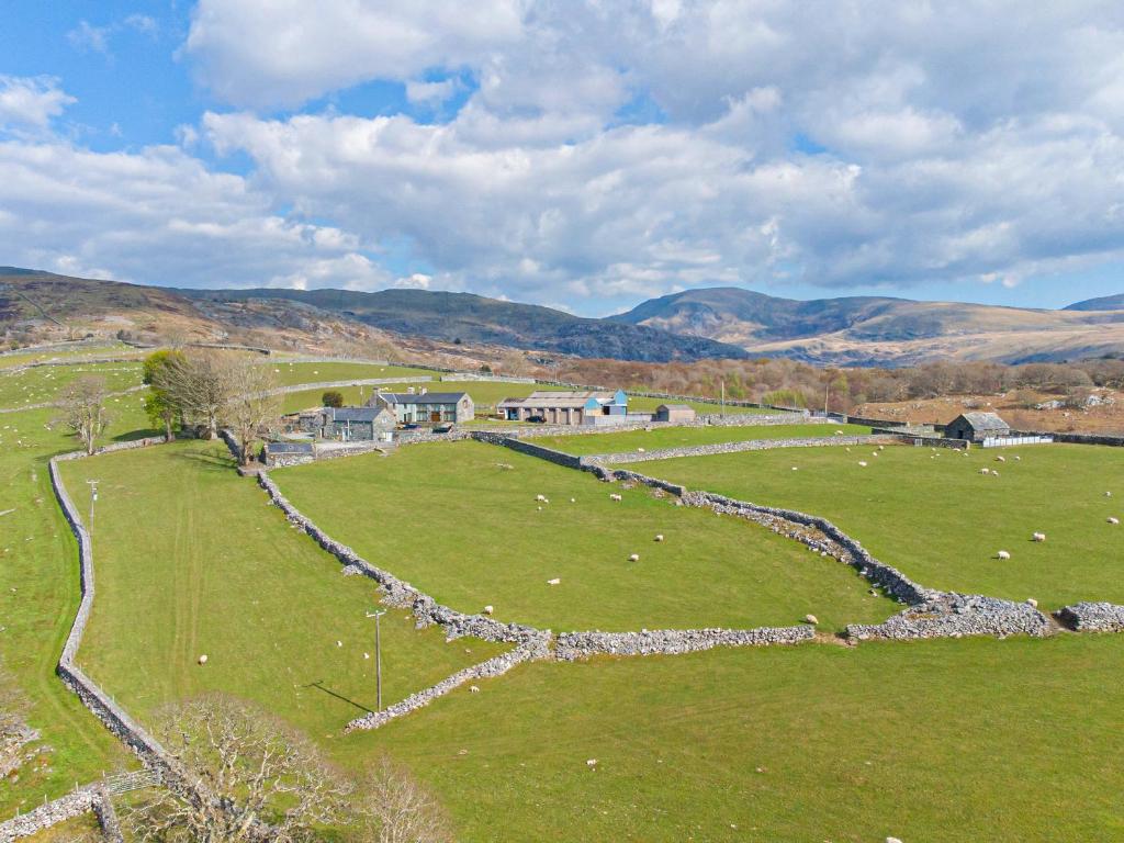 an aerial view of a pasture with sheep in a field at Cwm Nantcol Barn in Llanbedr