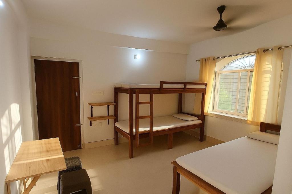 a room with a bunk bed and a window at ISKCON Mayapur Apartments - Daily & Monthly Rentals- PRIME LOCATION - SERVICED Apartment, 5 MIN to MAIN ISKCON TEMPLE in mayapur