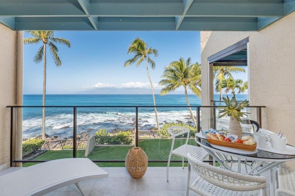 a dining room with a view of the ocean at Napili Point C3 · NP C3 Renovated OceanFront to Whale Watch Rela in Kahana